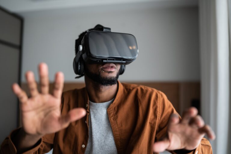 Young man using a virtual reality glasses at home (Photo: Getty Images)
