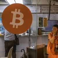 A Woman Uses Her Phone Outside A Cryptocurrency Exchange In Hong Kong - Hometown Register